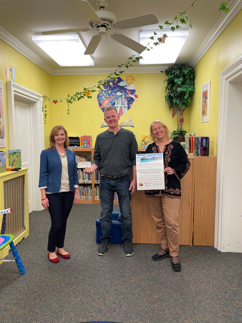 Rockwell Travel donated $2,600 in cruise proceeds to the Wayne County Public Library. Pictured are Amanda Kerna, chair of the library board, left; Mike Dux from Rockwell Travel; and Tracy  Schwarz, library director.